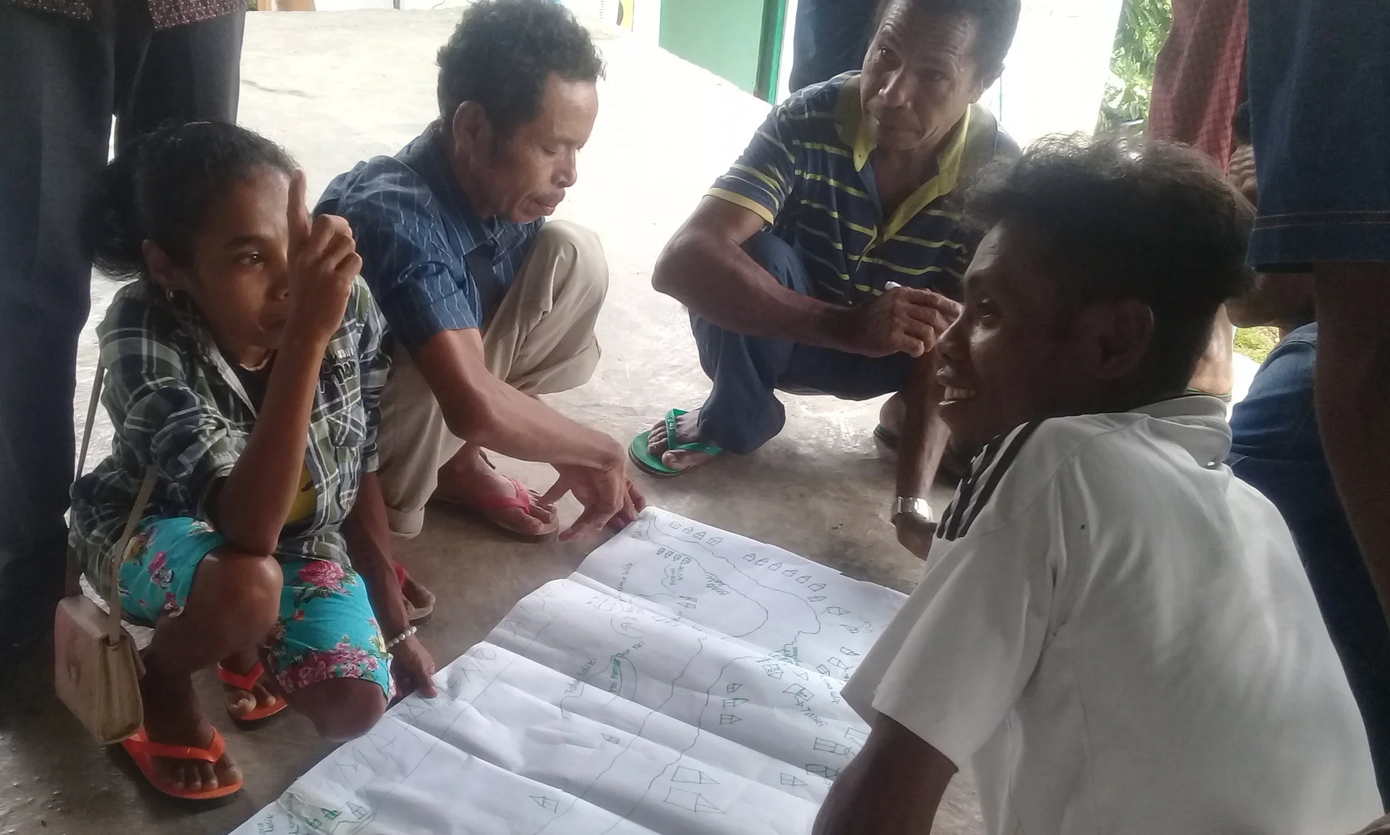 Above: Adelina participates in a community risk mapping exercise. Photo credit: World Vision Australia.