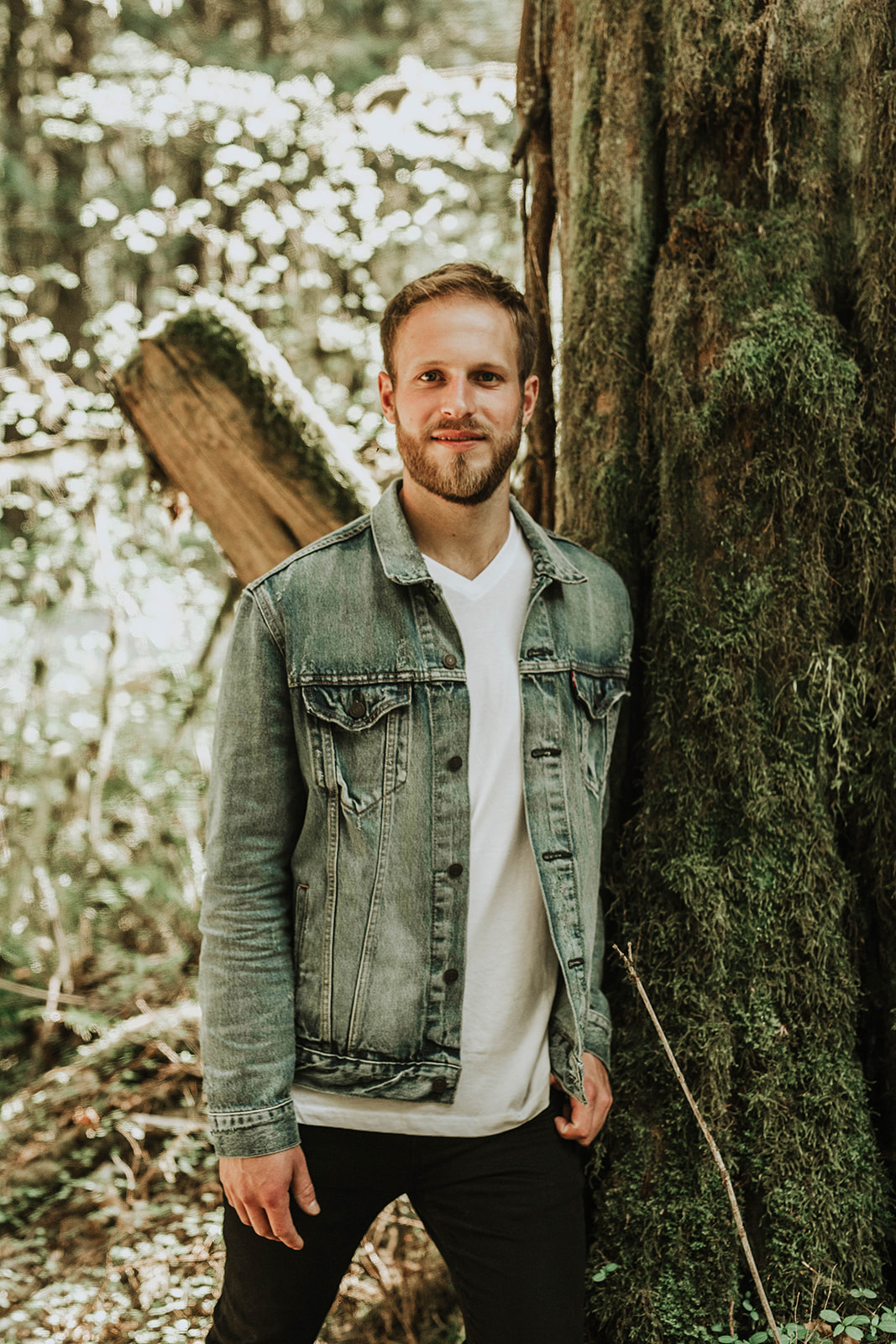 man standing tall in forest