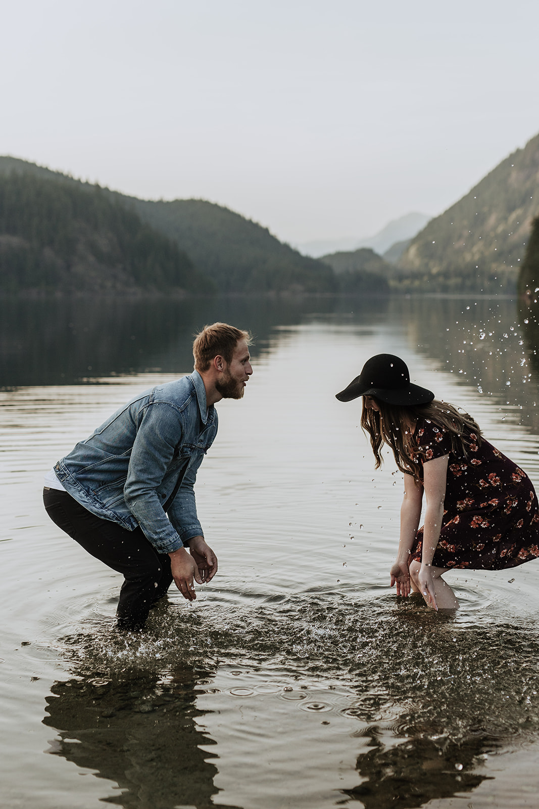 a couple splashing each other with water