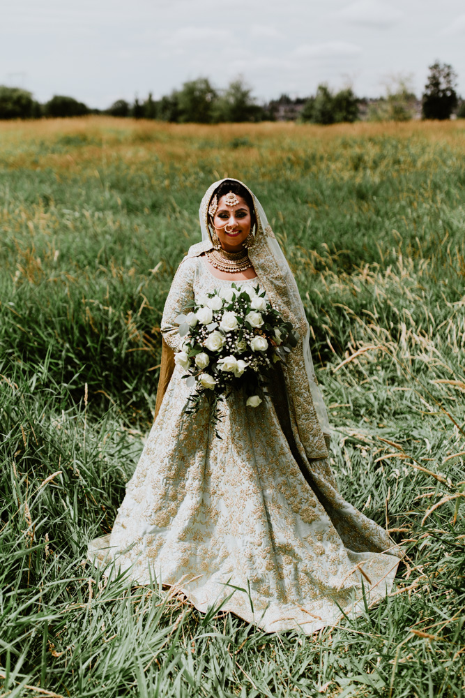 Indian bride standing in field
