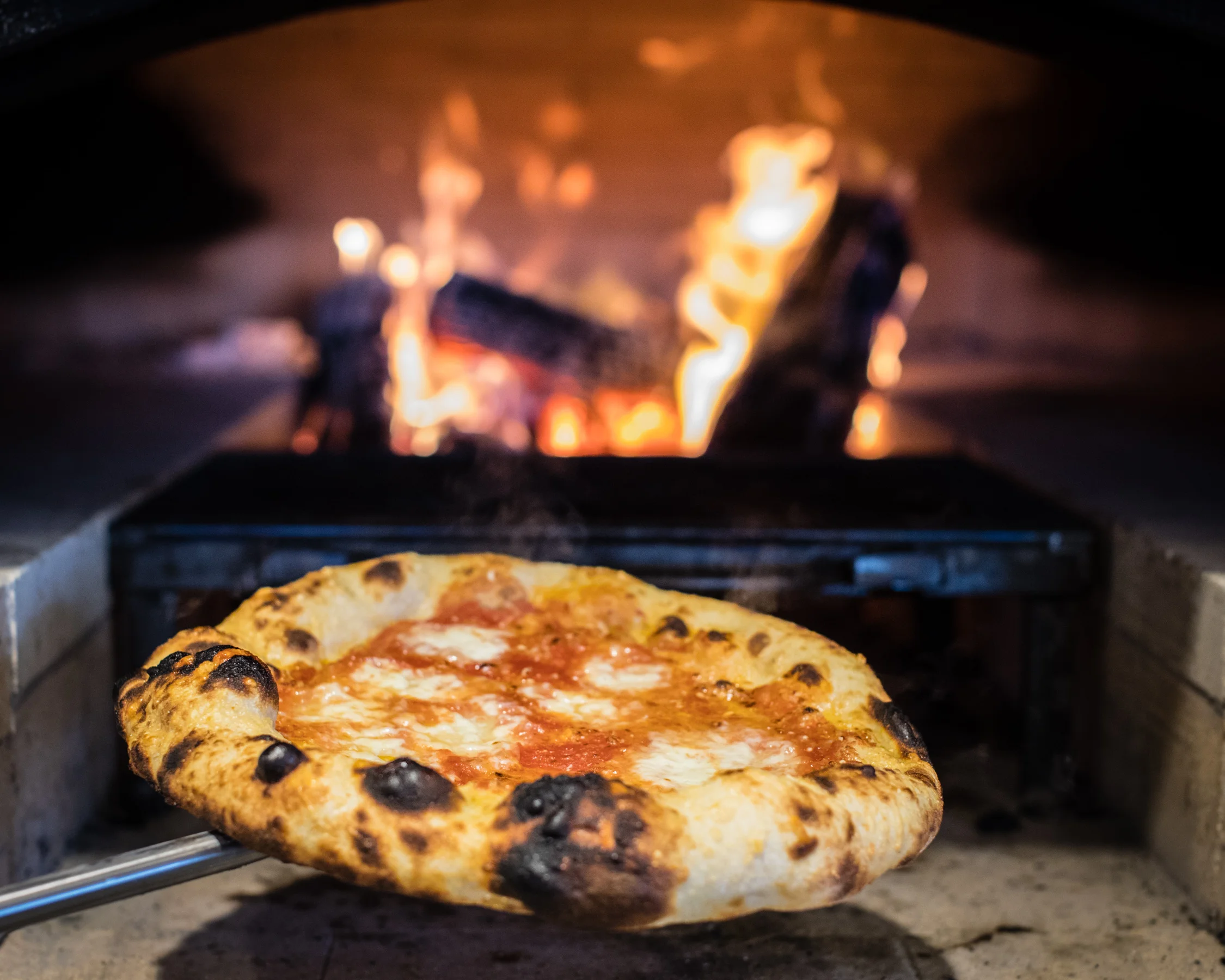 Pizza coming out of oven.jpg