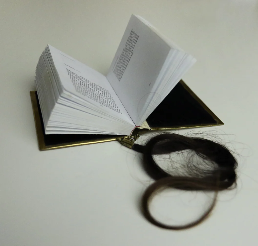    K’ dream. Object Book, Metal cover engraved by hand, printed paper and human hair, 7 x 2.4 x 0.75 in - 8 x 6 x 2 cm. 2011     