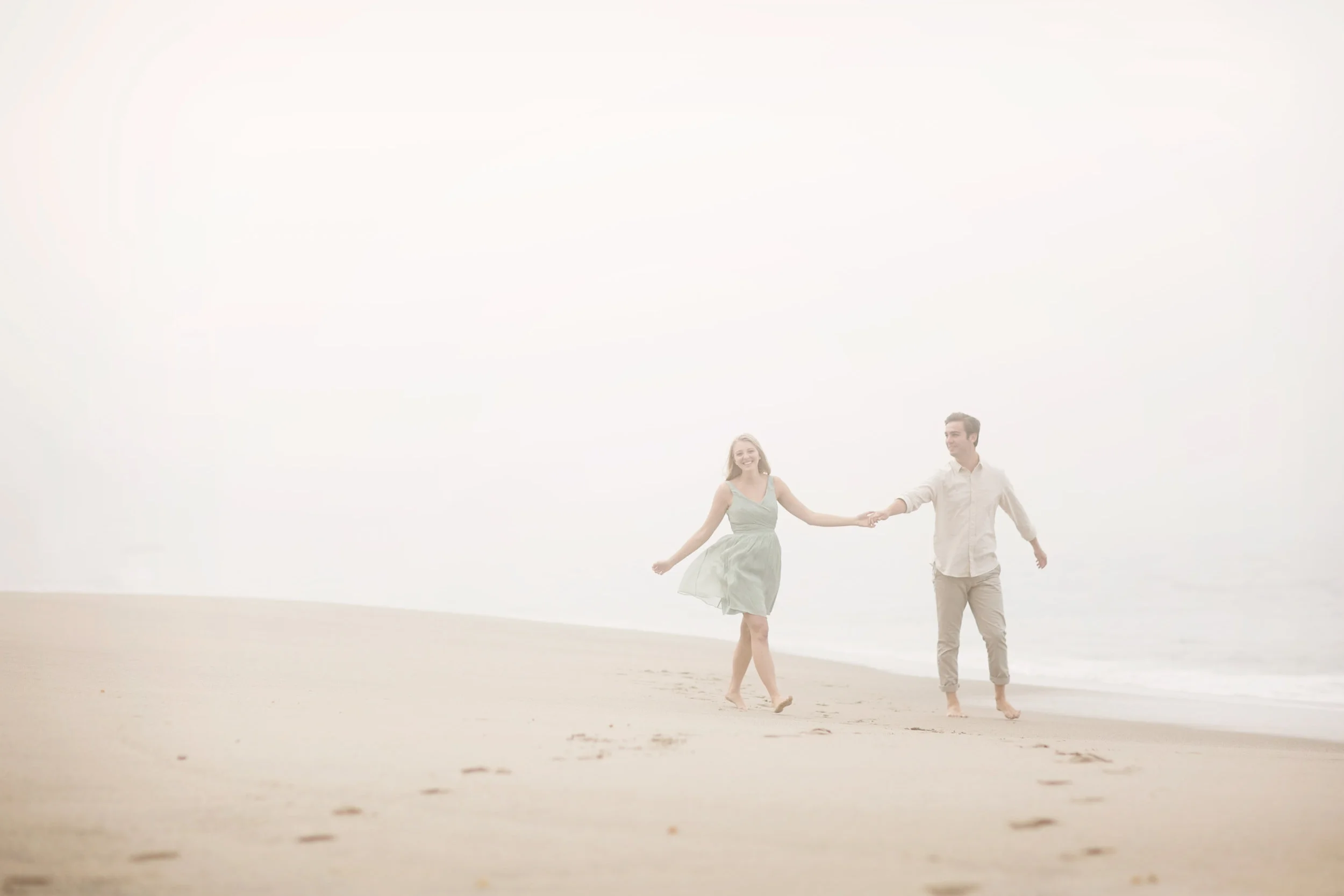 A foggy day at the beach makes the perfect beach portrait for this engaged Orange county couple.