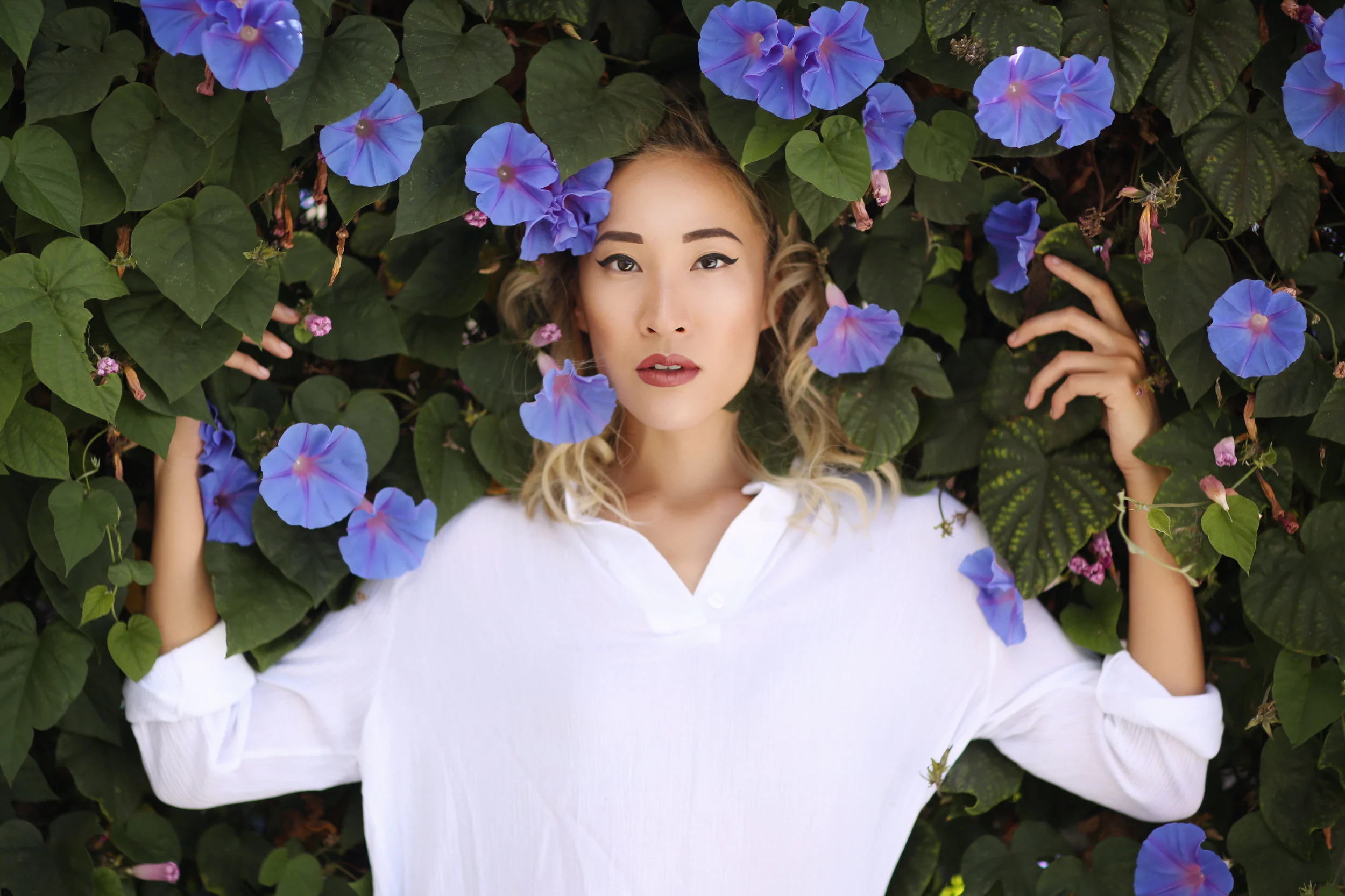 Feast Fashion Faves Amanda Nguyen portrait in the morning glory flowers