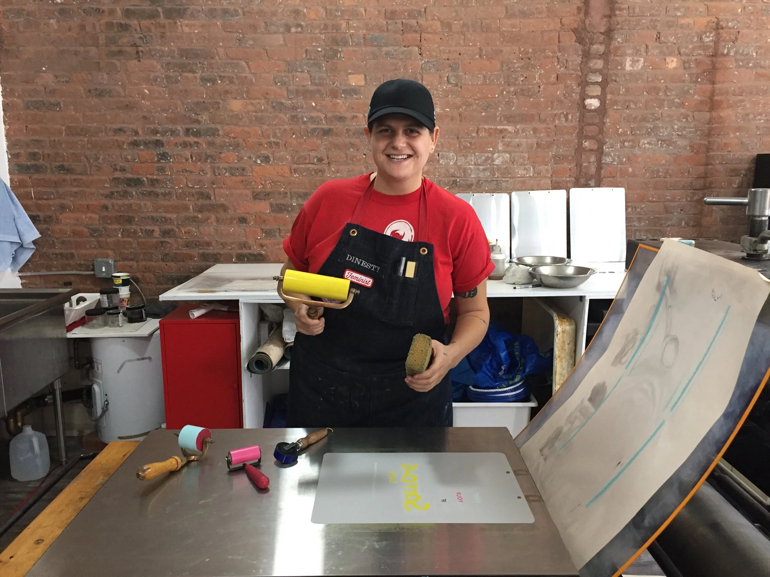 Nina Dine is a Tamarind trained master printer and loves the technical challenges and quirks of lithography. She has gathered extensive knowledge of the collaborative print process in a professional workshop setting after working in print shops around the world including New York City, Walla Walla, WA, Madison, WI,  and Berlin. She is also the master mixologist at the studio!