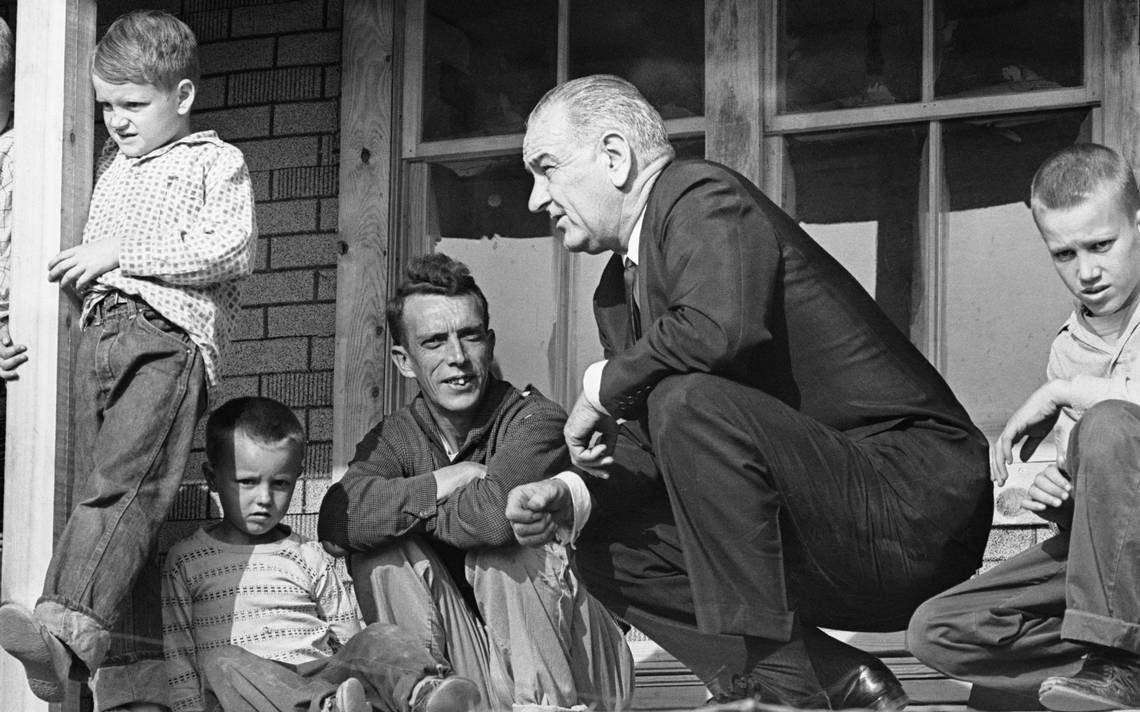 President Lyndon Johnson visits a family living in poverty in 1964. Photo by Walter Bennett/Time & Life Pictures/Getty Images