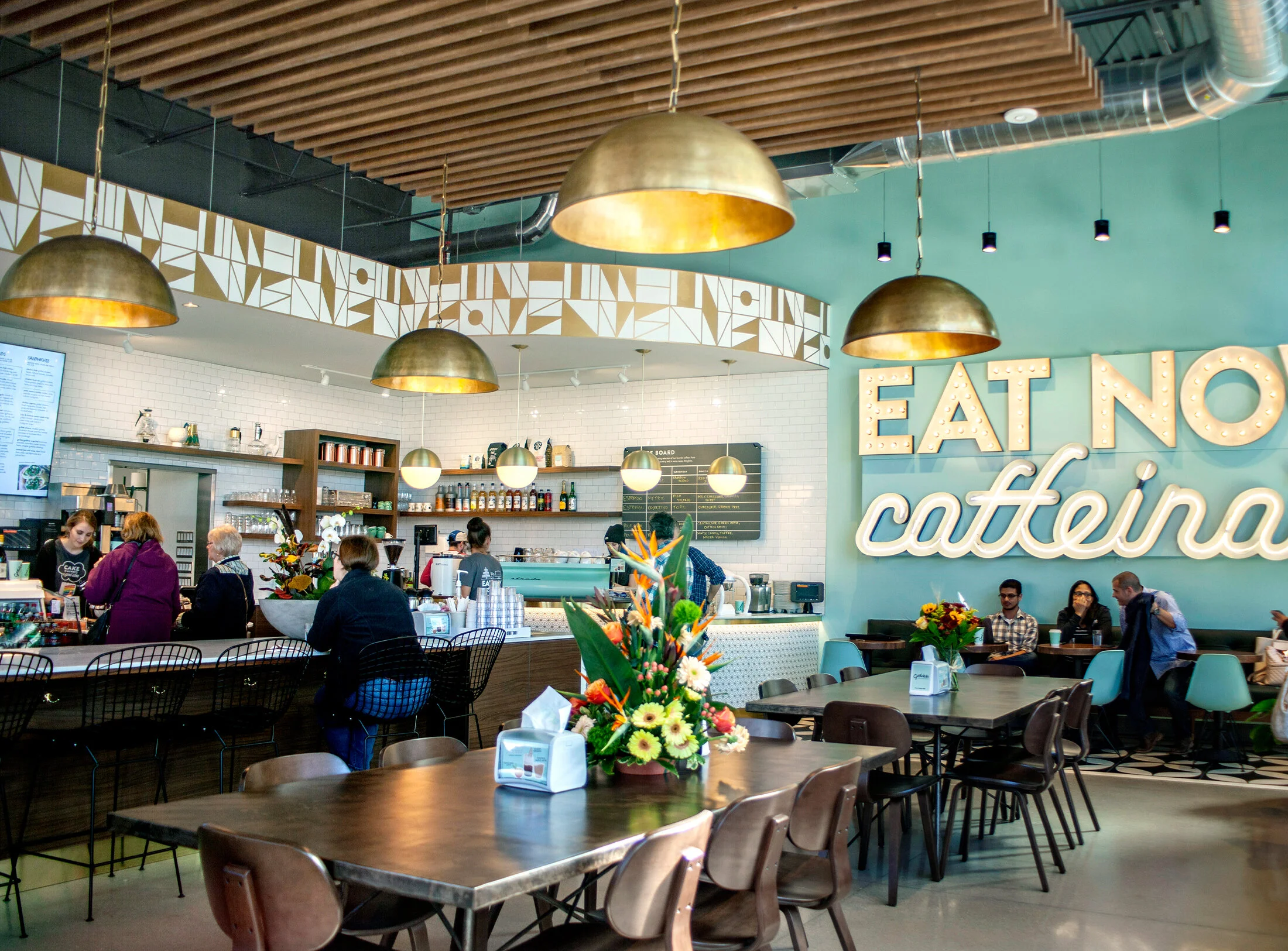  Pulling cues from Debbie’s catering experience with actual rockstars, we created gold patterns that played off elements of the space. The geometric soffit has a midcentury feel much like the vibe of the furniture, the color blue, and hanging light f