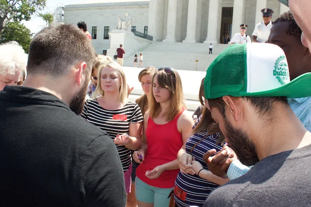 Following the ruling, Matt Lockett leads a group in prayer and communion outside the Supreme Court (Photo: Josh Shepherd)