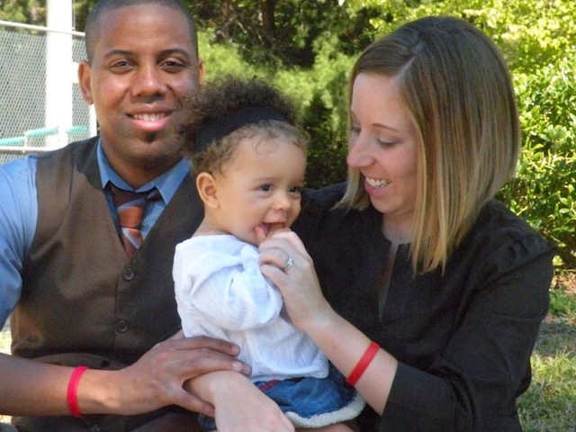 Holding their daughter, Cathy and Marcus Harris wear Life Bands—a daily reminder to pray for life (Photo: Harris Family)