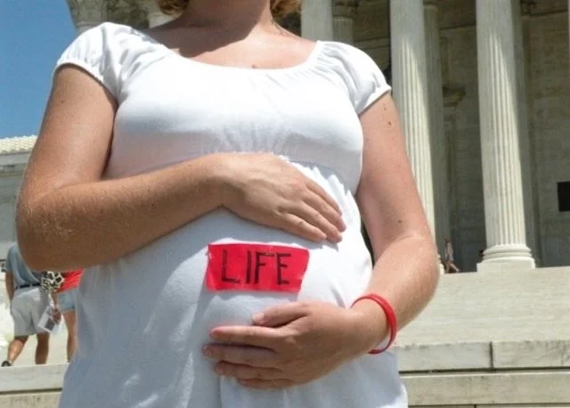 Today a mother of three, Cathy wore Life Tape during her pregnancy as a public witness (Photo: Harris Family)