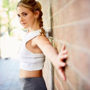  Alex Silver-Fagan Instagram model posing with back and hands against brick wall 