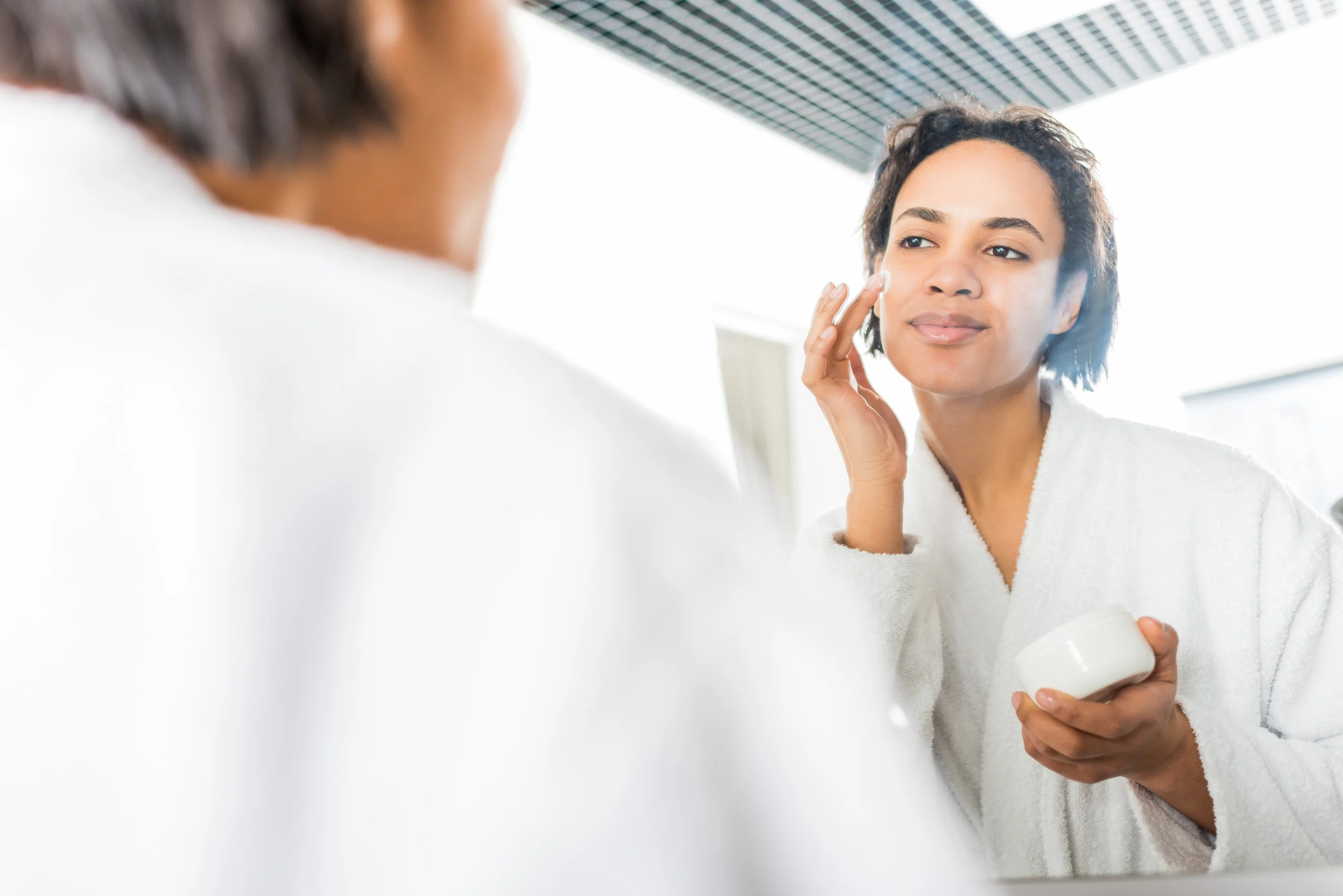 Woman-putting-on-face-lotion.jpg