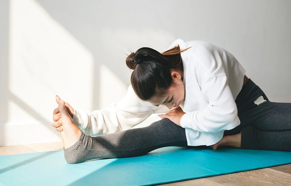 Woman-stretching-on-yoga-mat.jpg