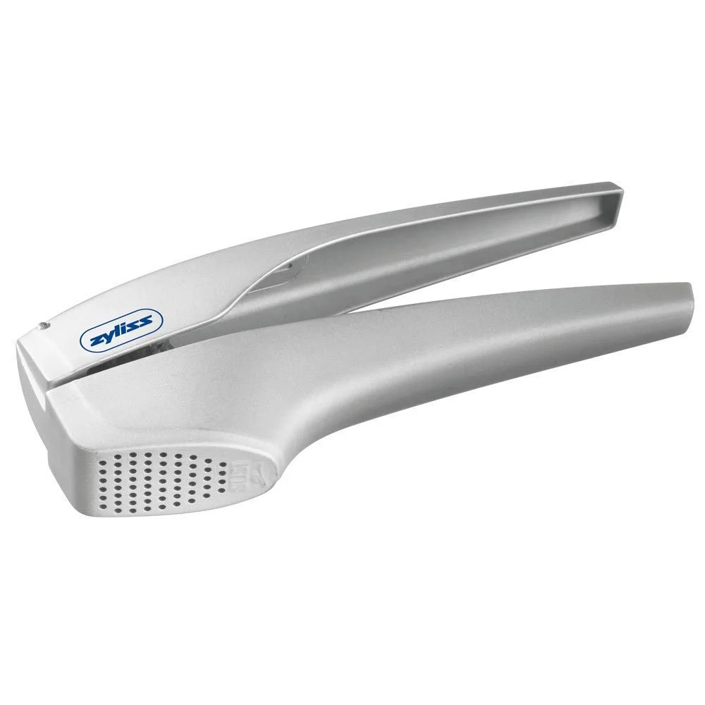 Zyliss Garlic Press Sturdy cast aluminum garlic press quickly and easily minces garlic with no need to peel the clove Lightweight ergonomic handle makes pressing garlic or ginger easy Generous size hopper accommodates large garlic cloves Built in cleaning tool fits holes perfectly and makes quick work of cleanup Zyliss 5 Year Manufacturer Guarantee - Dishwasher Safe, Hand Wash Recommended