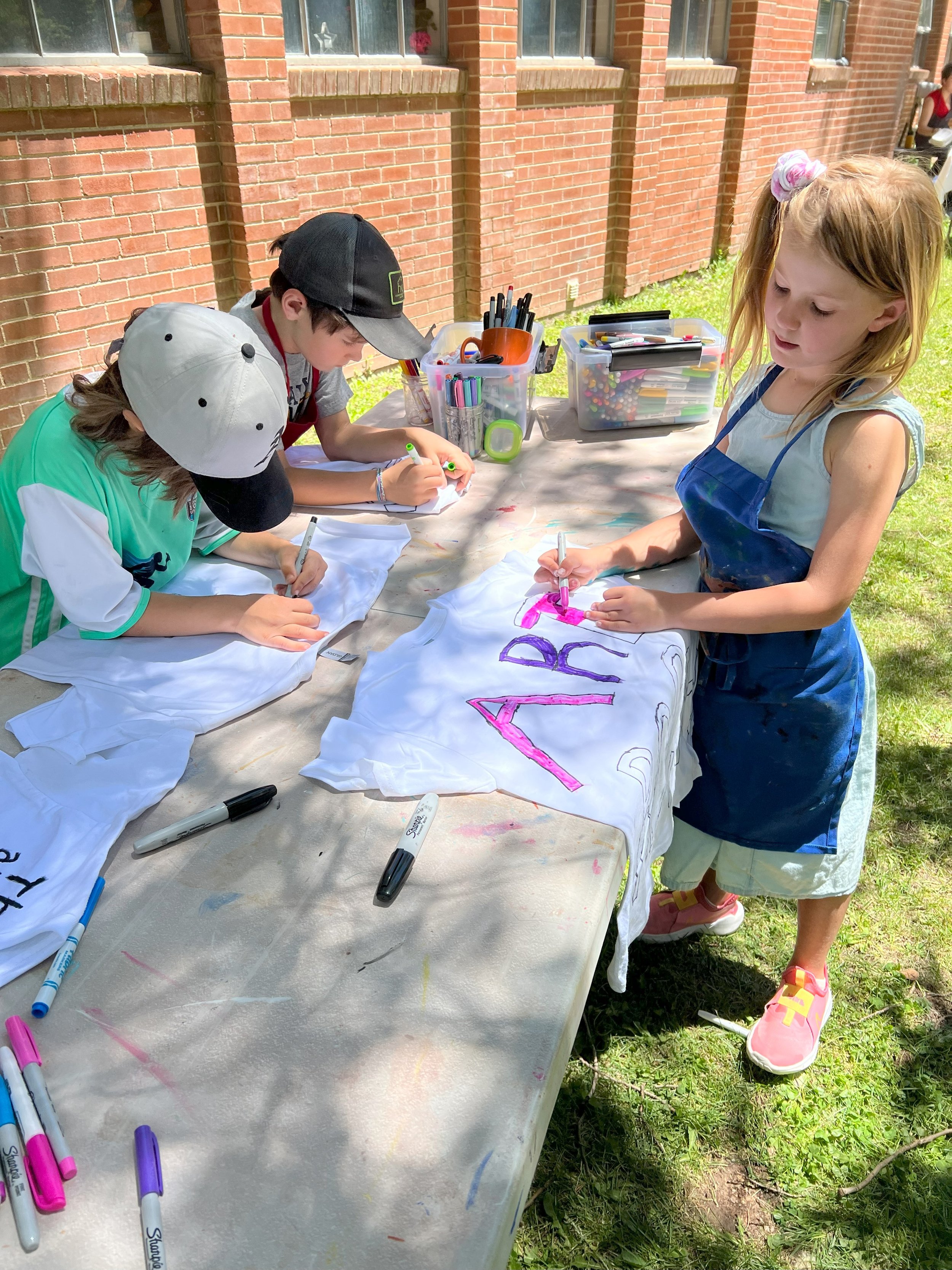 Three students working on tee shirts.jpg