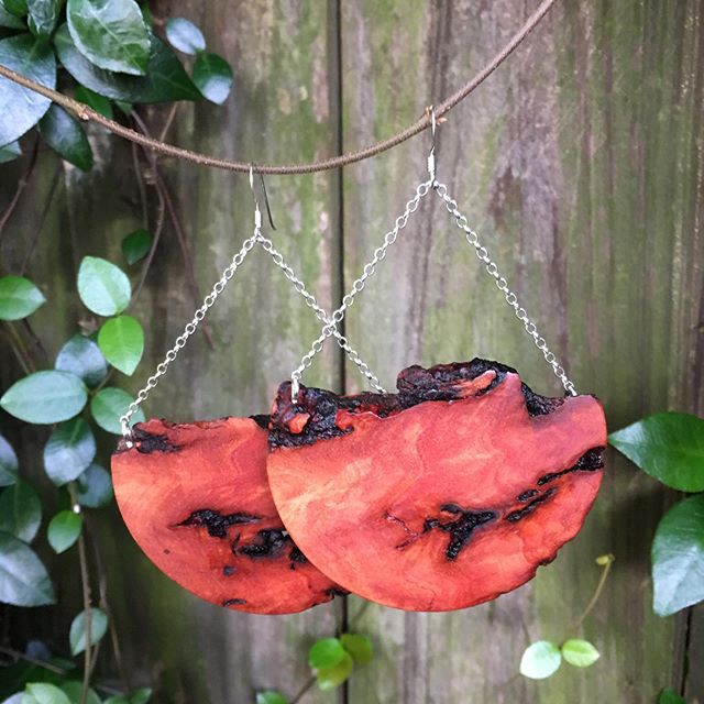 This extra large earring &amp; necklace set is made from Australian Red River Gum, a member of the eucalyptus genus. It features a brilliant glowing orange-red color and deep-scarred cracks and cavities throughout the lumber, giving it an extremely u