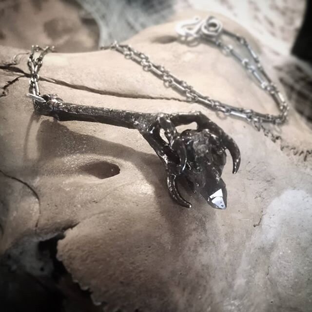 We'll be bringing this Reliquary Necklace with a Bird Foot clutching a cluster of Smokey Quartz to our first travel show of the year --- the Charlotte @odditiesandcuriositiesexpo on Feb 15th!

This one of a kind piece features an electroplated bird f