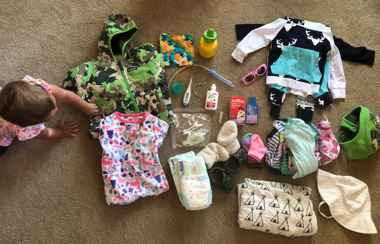 ( I removed some things from our pack from this photo but wanted to give you an idea. Removed: the white/blue deer outfit and all but three onsies you see stacked there)