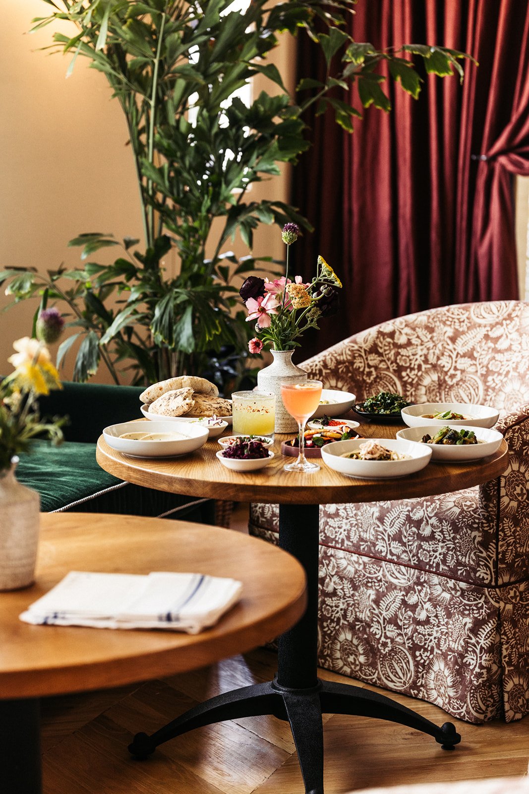 wooden table filled with plates of food