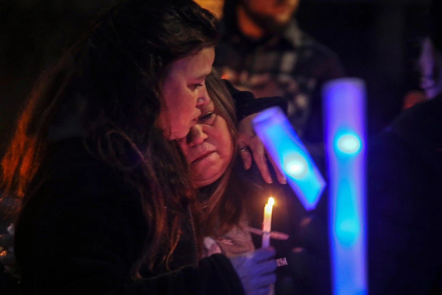 Toledo police Officer Brandon Stalker's mother Cosette Stalker is comforted as family, friends, and fellow officers gather at a vigil in West Toledo on Wednesday, Jan. 18, 2023. Officer was killed in the line of duty Jan. 18, 2021. Cosette said at th