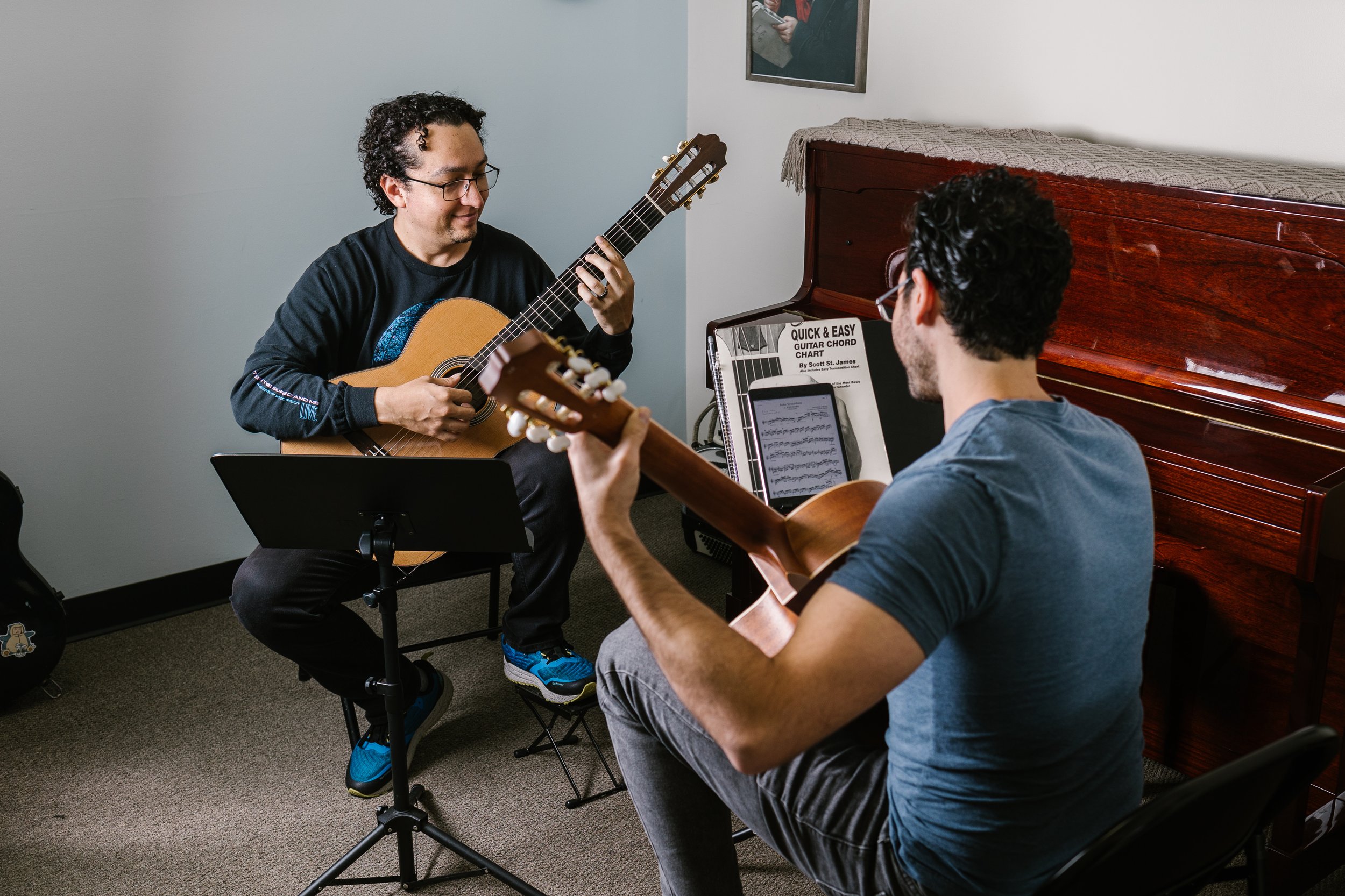 Guitar teacher with student in classroom.jpg
