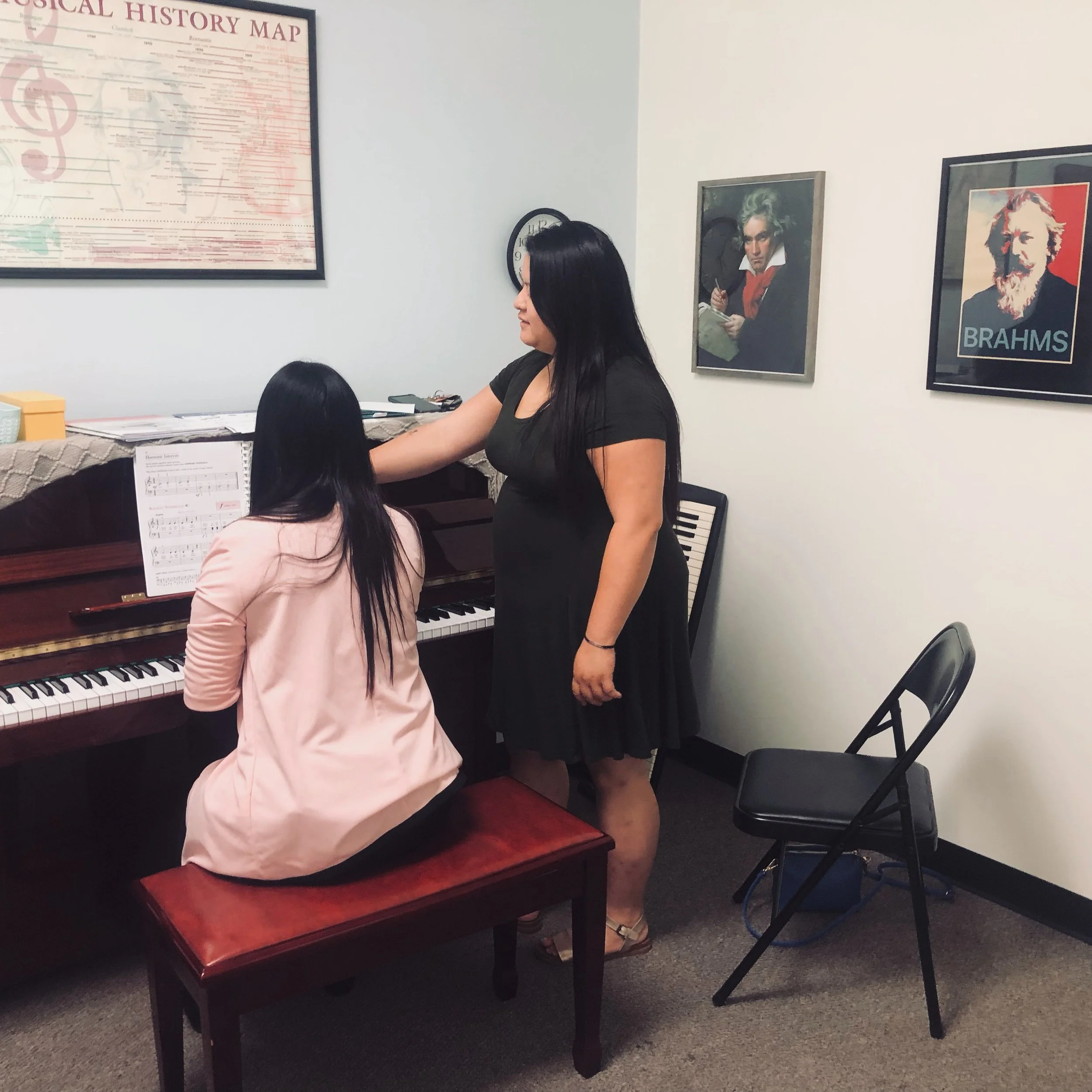 Piano teacher with student pointing at music.JPG