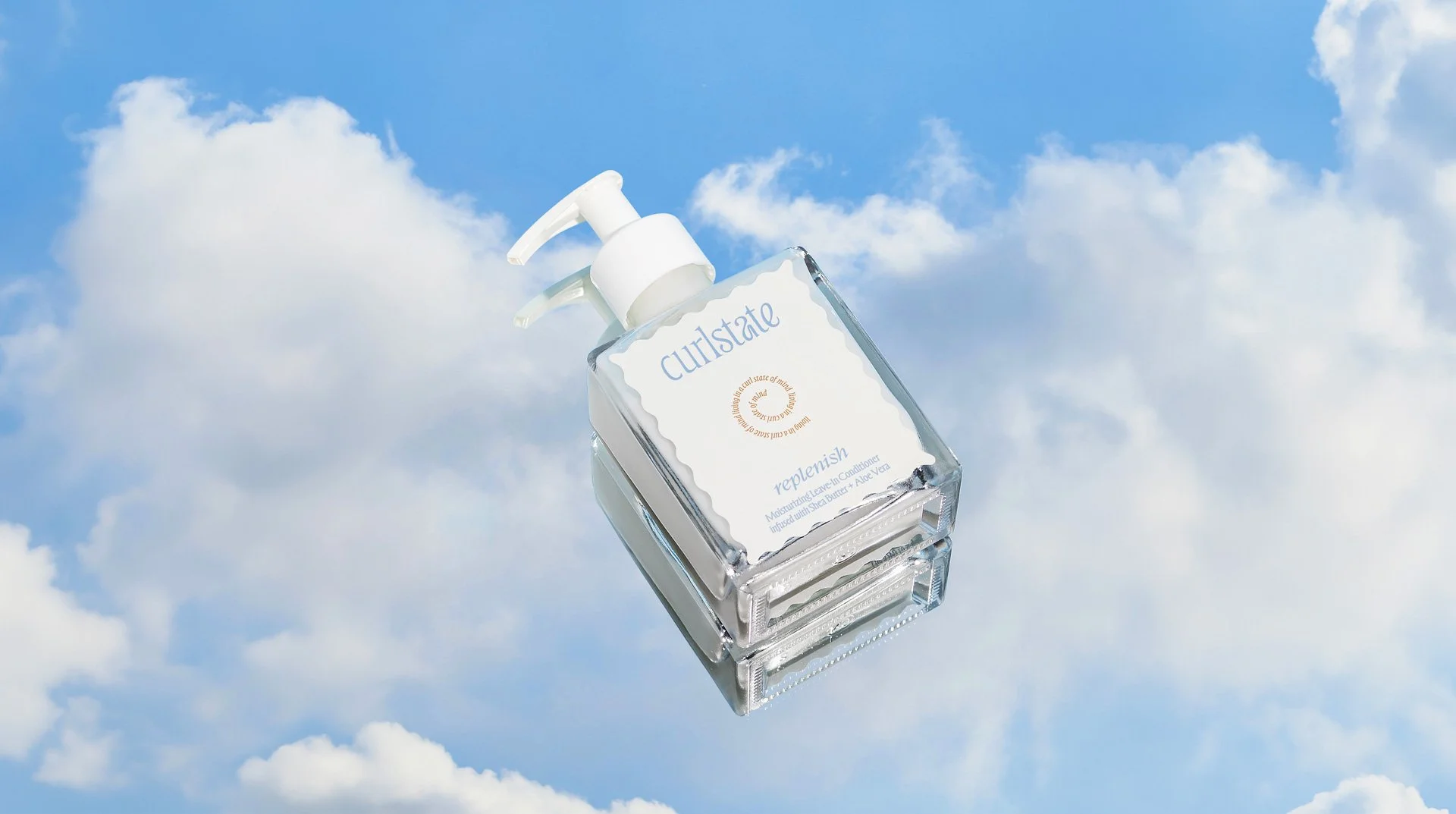 A clear bottle of moisturizer with a pump dispenser labeled 'culstate replenish' floating in a blue sky with white clouds.