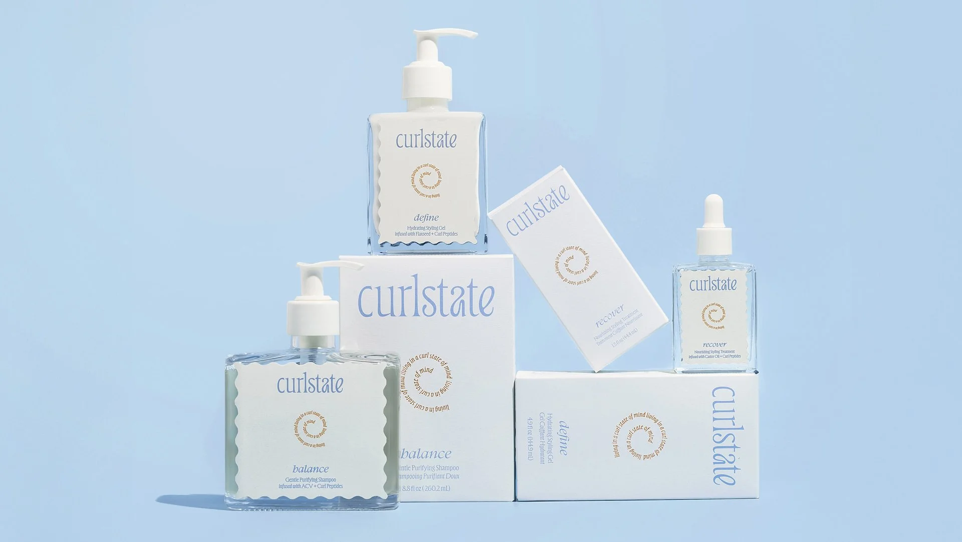 Collection of Curlstate hair care products including shampoo, conditioner, and scalp treatment on a light blue background.