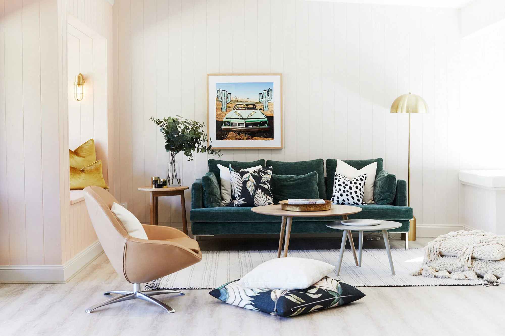 Three Birds Renovations River Shack living room with green velvet sofa, layered textures, timber tables and relaxed modern styling.
