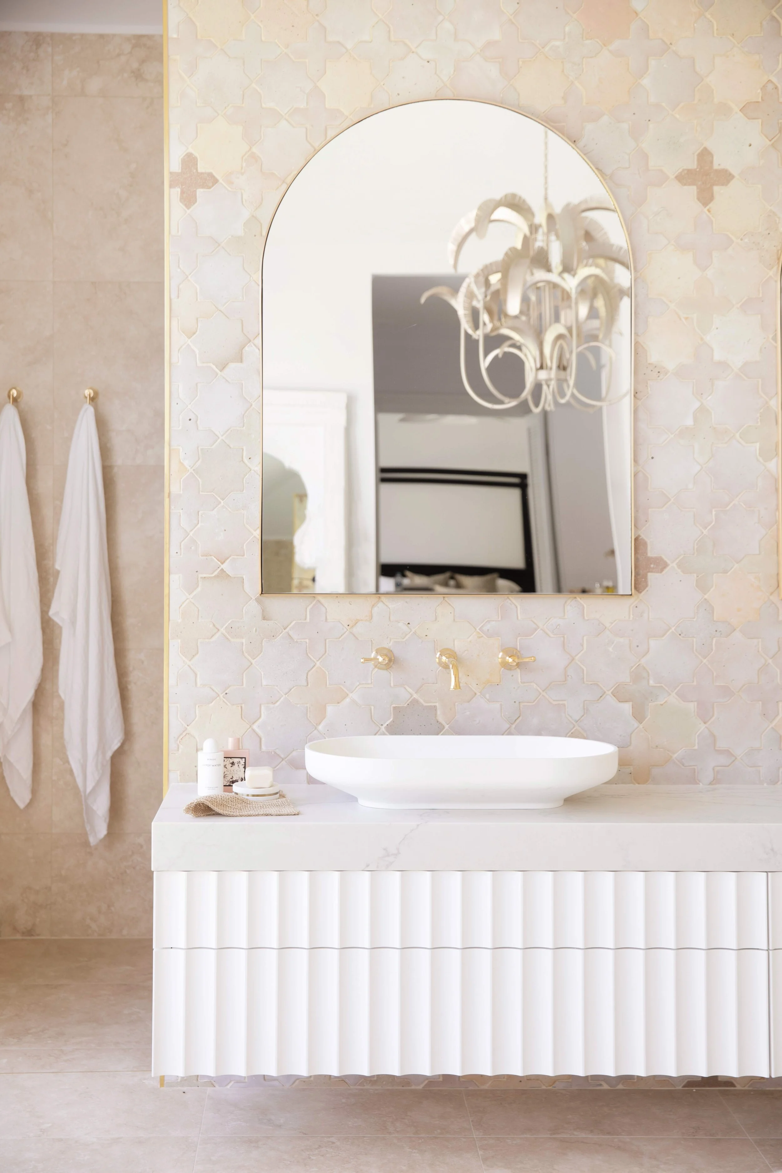 Three Birds Renovations House 13 bathroom with fluted vanity, vessel basin, brass tapware and patterned tiled feature wall.
