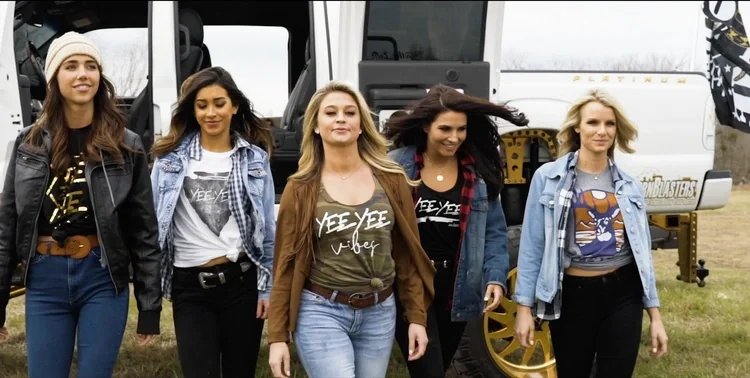 Cast members wearing Yee Yee apparel walking in front of a lifted truck for the Granger Smith music video.