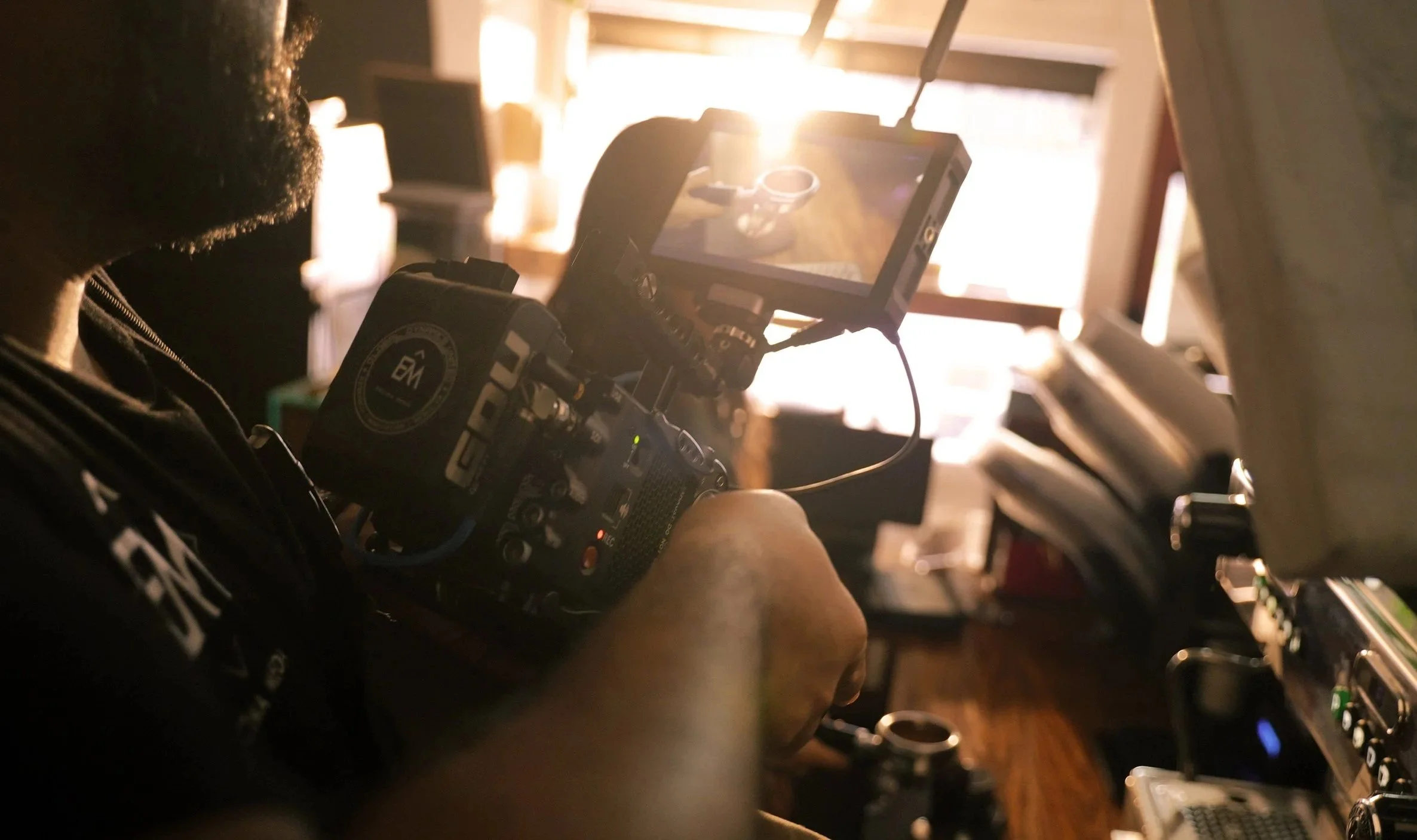 Cinematographer operating a professional camera rig during a behind the scenes commercial video shoot.