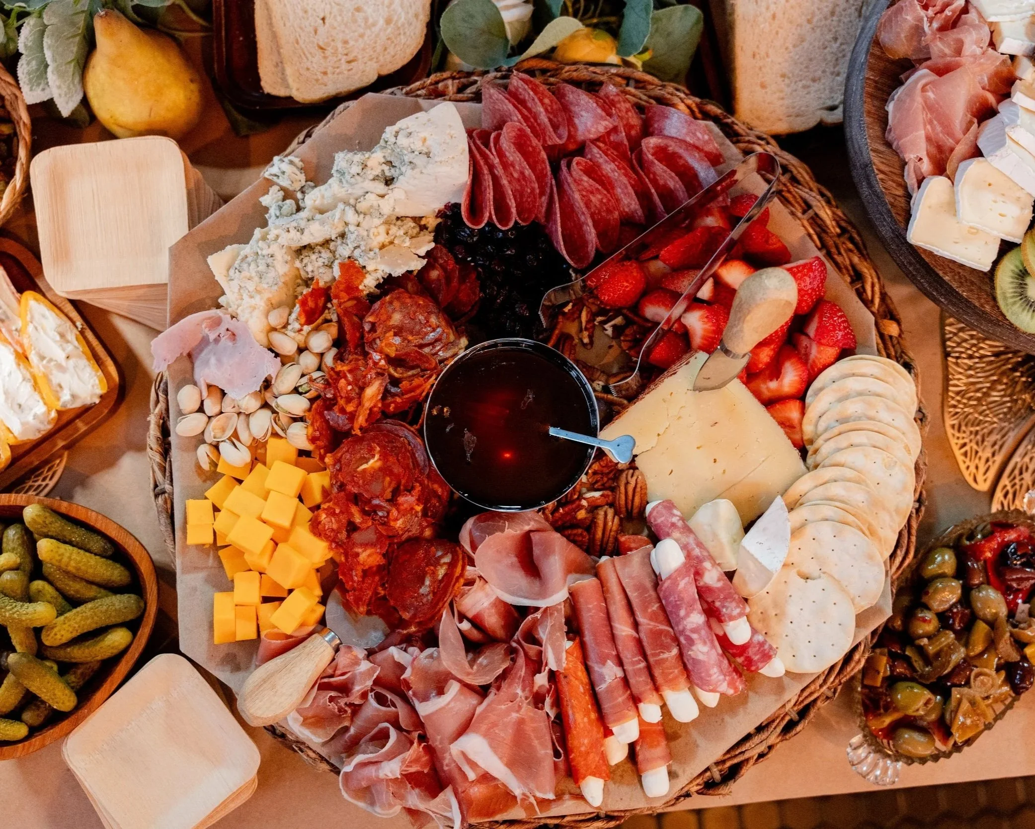 
Overhead view of a charcuterie board with cured meats, cheeses, fruit and crackers for hospitality content creation.