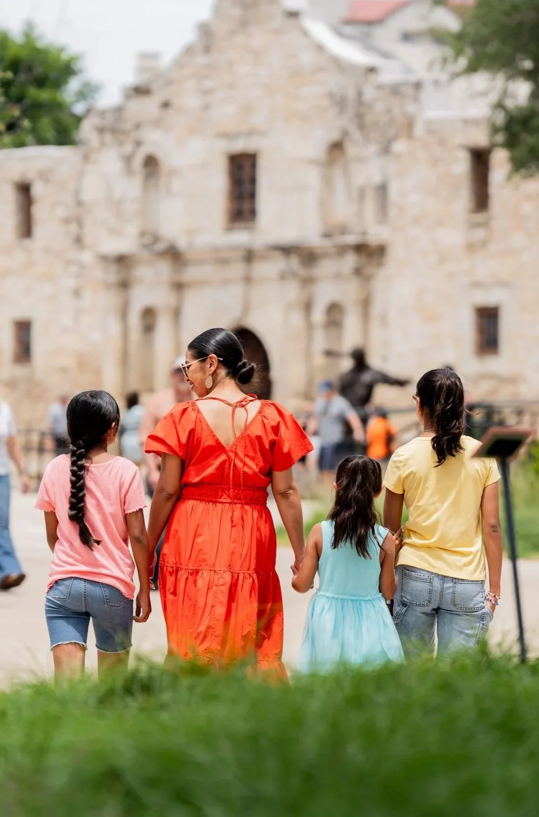 Mother and three daughters walking toward the Alamo in San Antonio Texas travel photography.