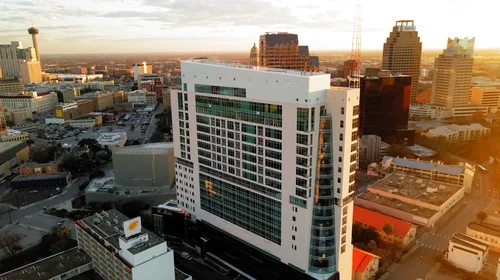 Arial view of the Thompson Hotel and surrounding city buildings.