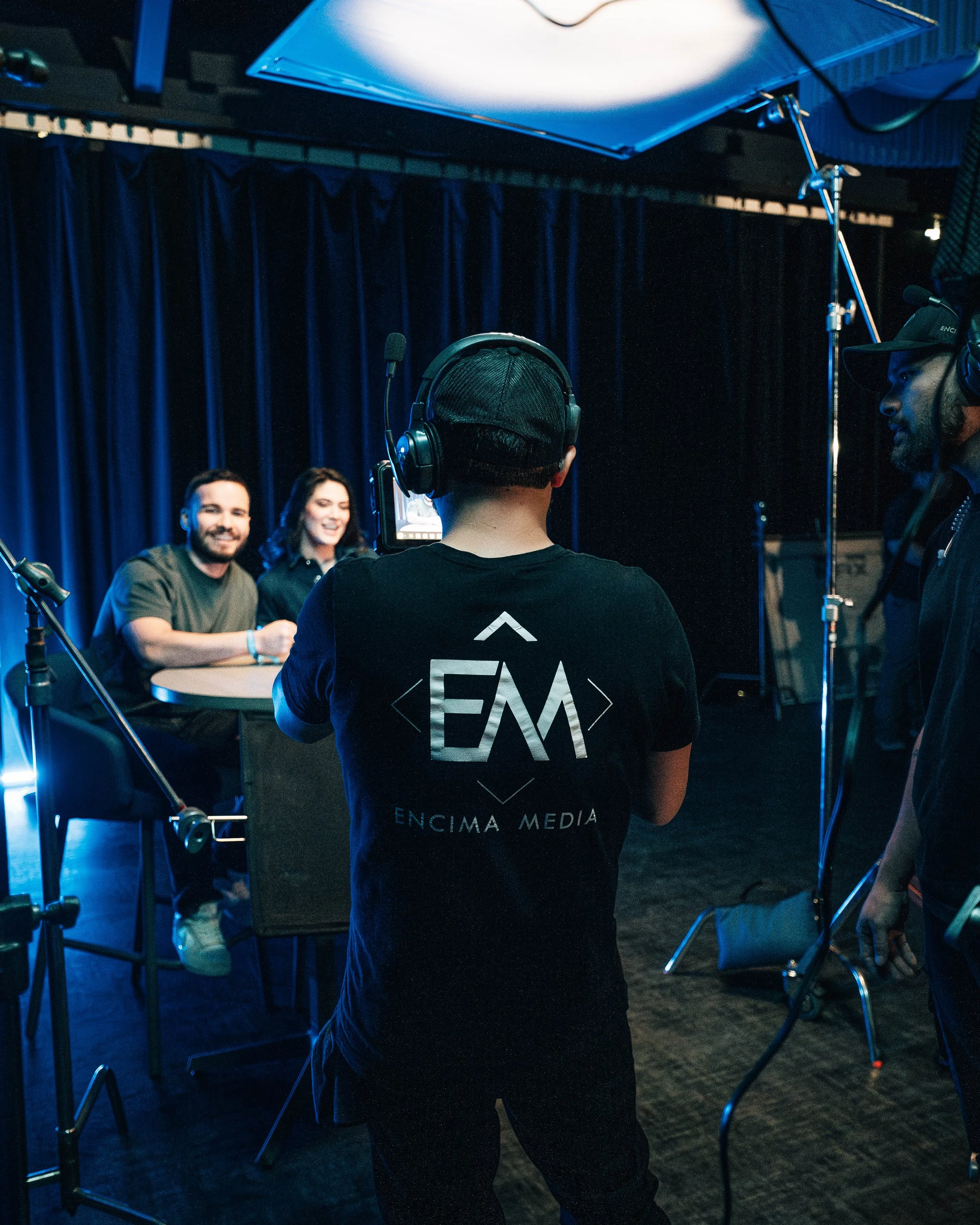 Video production crew setting up a professional interview shoot inside a commercial film studio