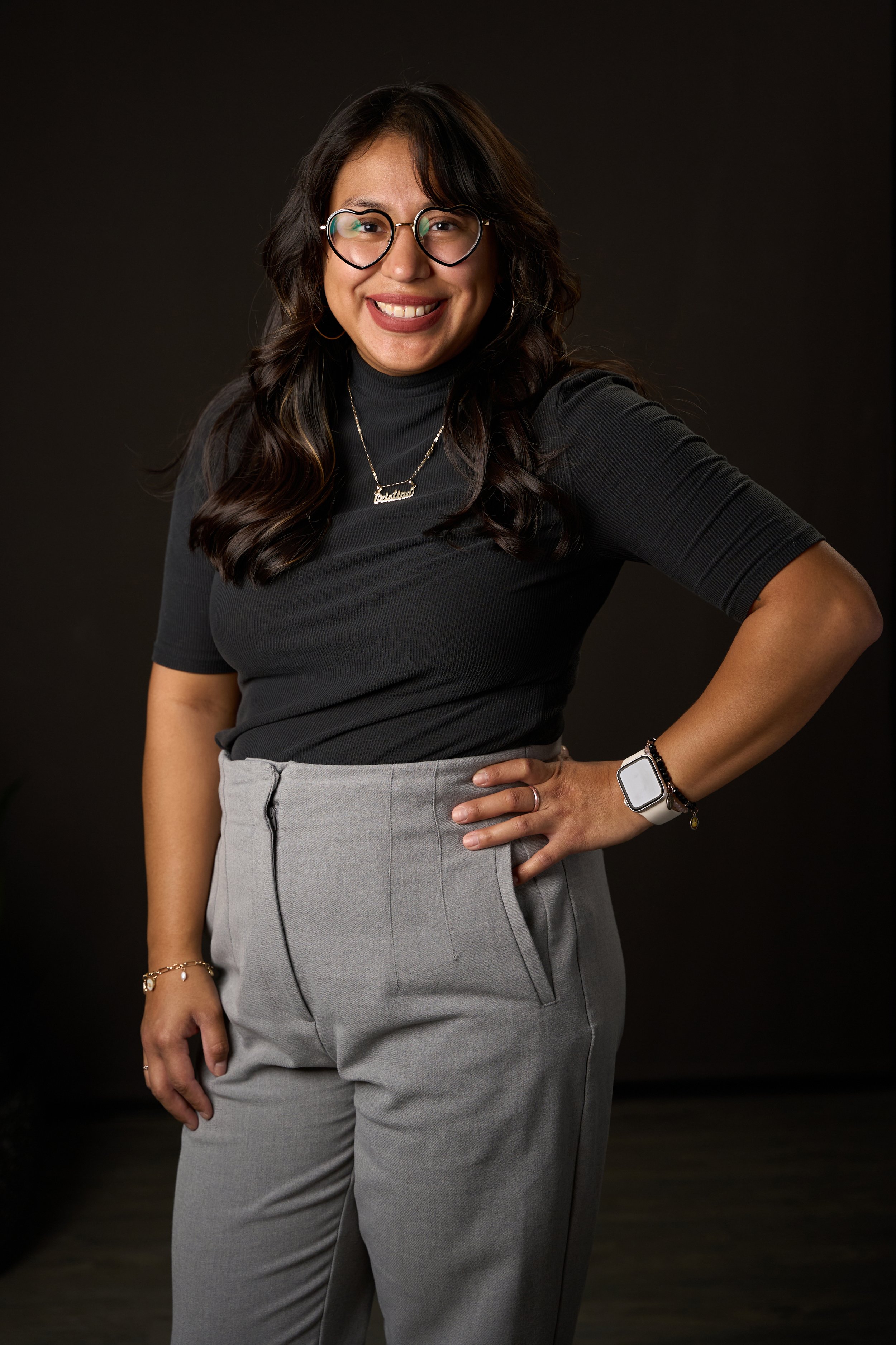 Studio portrait of a confident woman with heart-shaped glasses for professional branding photography.
