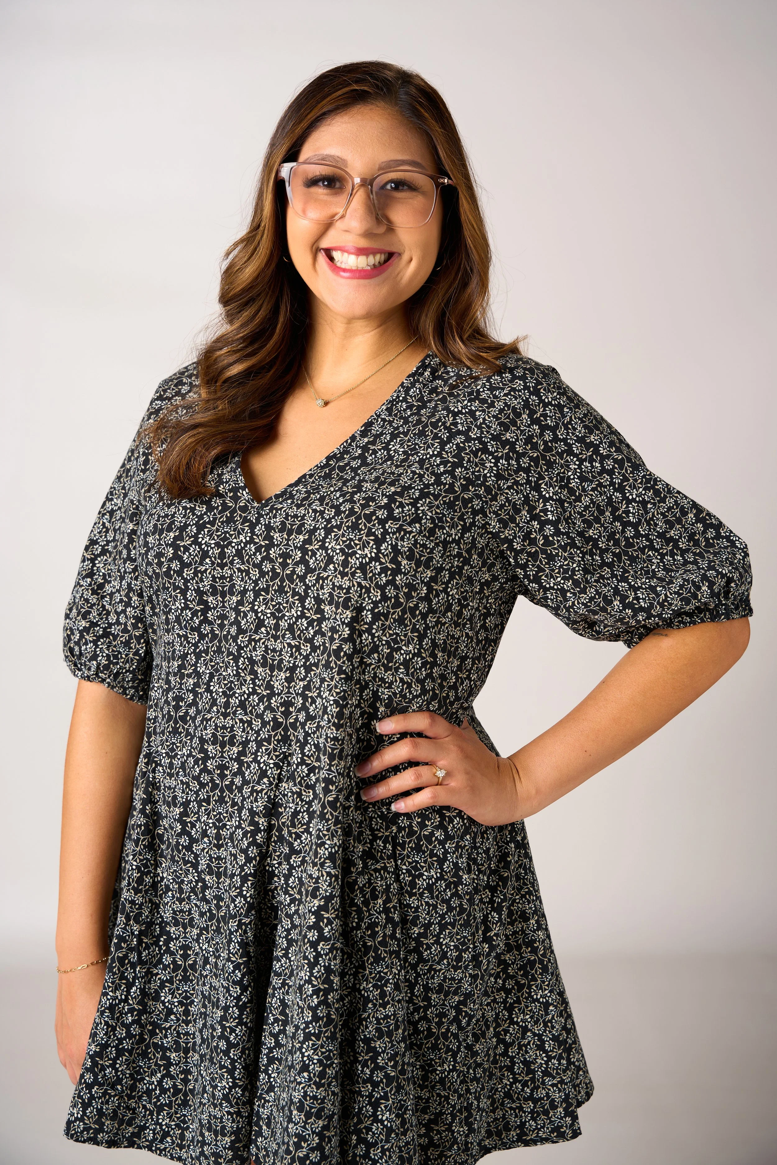 Professional headshot of a smiling woman in a studio for personal branding and commercial portrait photography.
