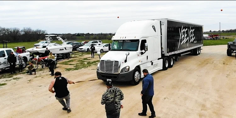 Video Production scene featuring a semi-truck pull with cast members and vehicles on the Holler set.
