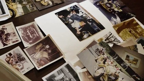 Vintage photos of the 1913 Mercer spread out for story development during commercial pre-production.