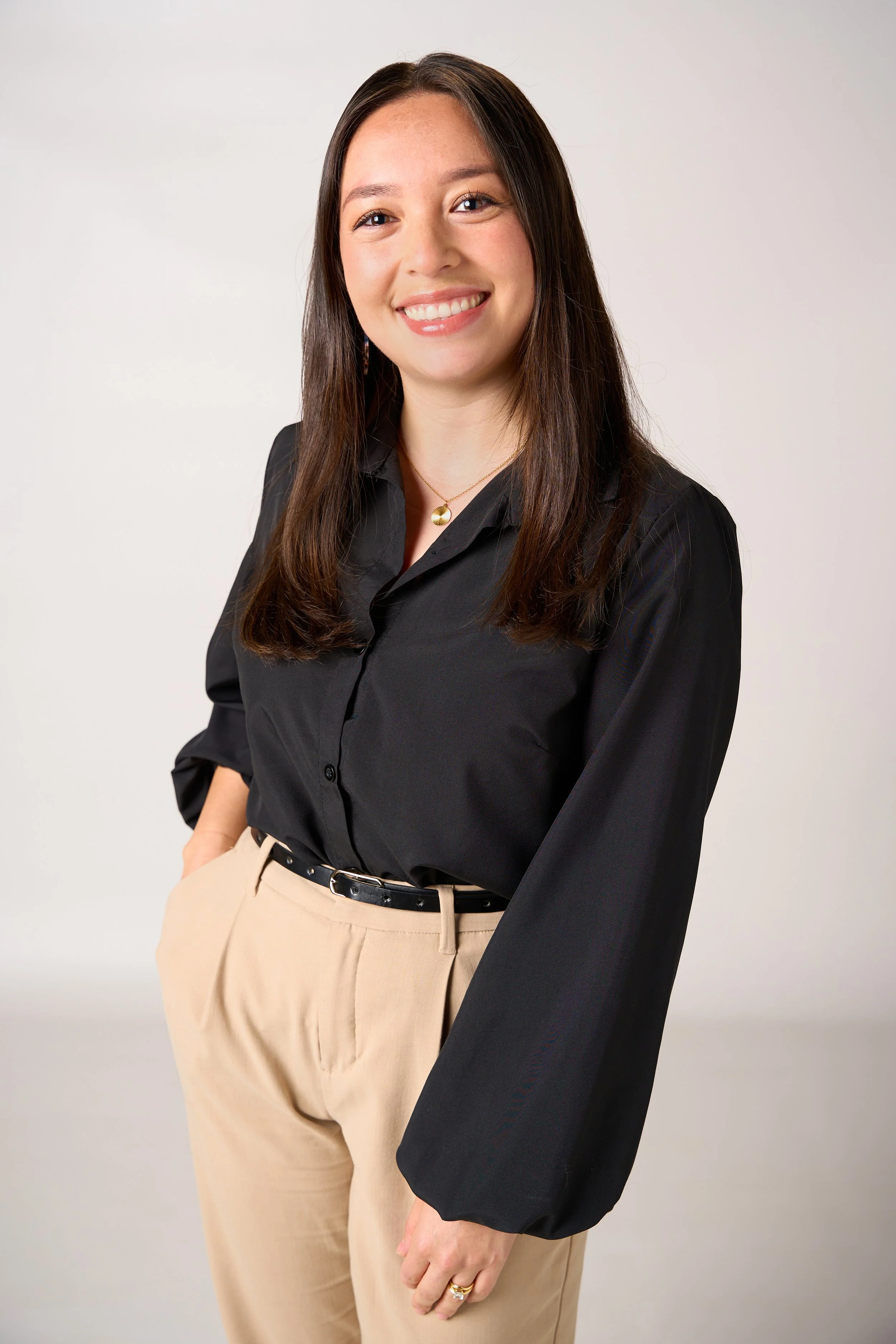Professional headshot of a smiling woman in a studio for personal branding and commercial portrait photography.