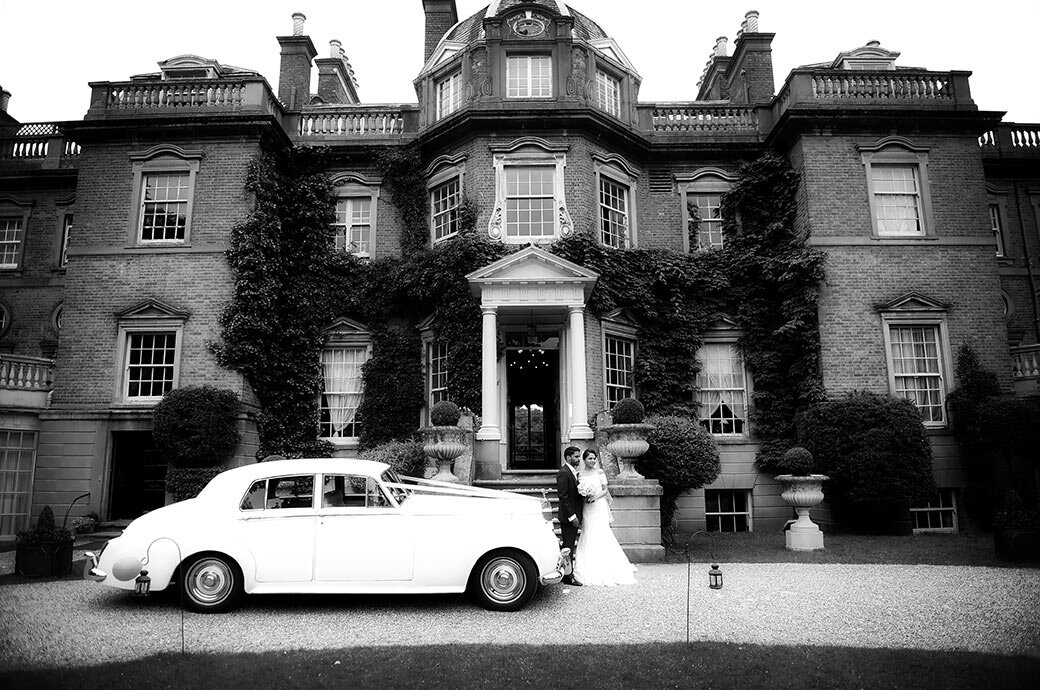 Hampton-court-house-wedding-couple-and-rolls.jpg