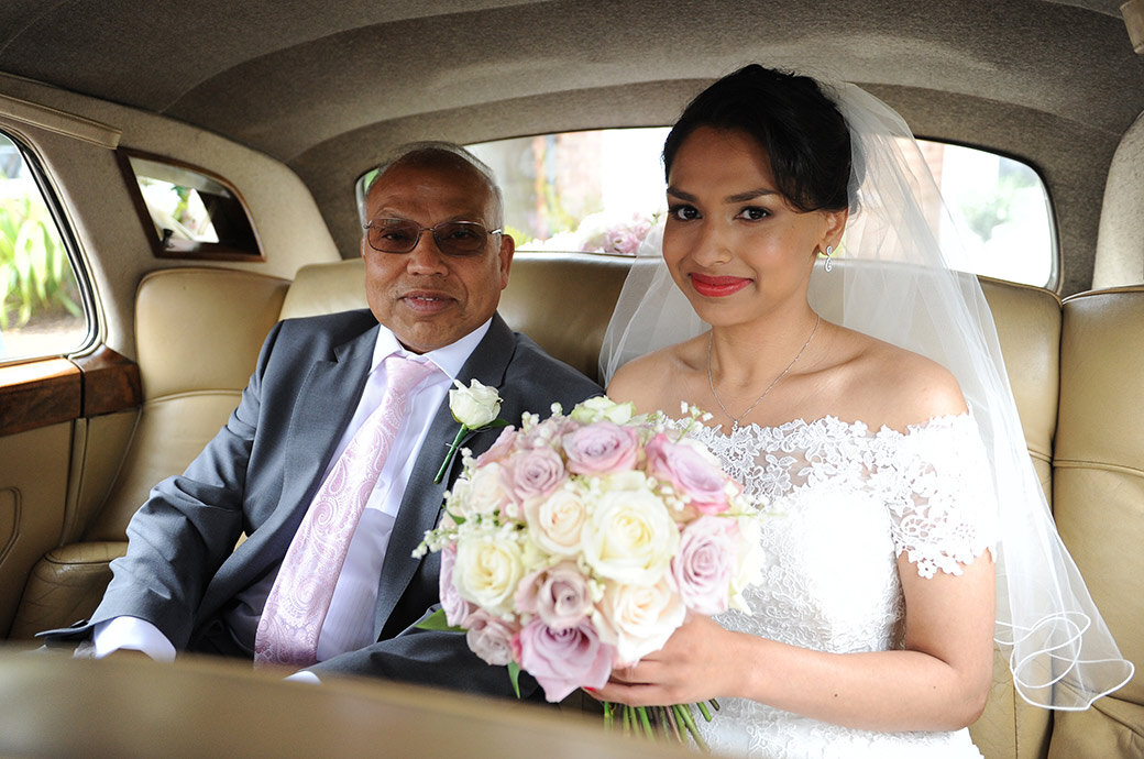 Happy-bride-in-wedding-car-to-hampton-court-hse.jpg