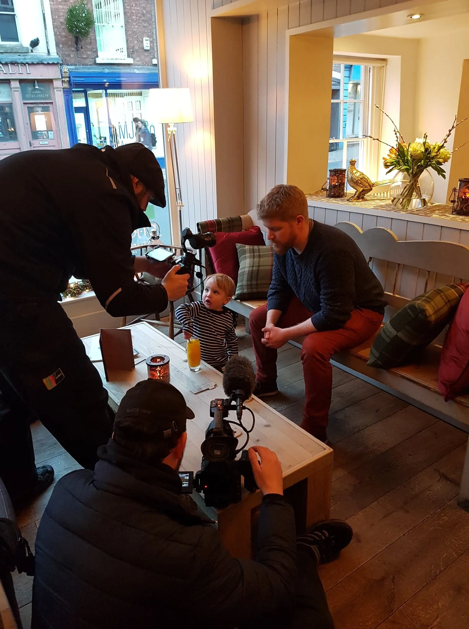  Pete and Simon from 7Video filming little Hector and dad in a restaurant.  