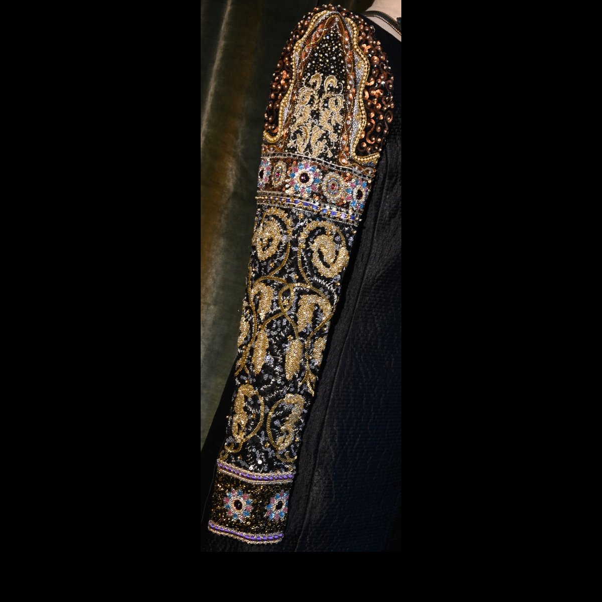 Detail of sleeve of black cocktail dress
