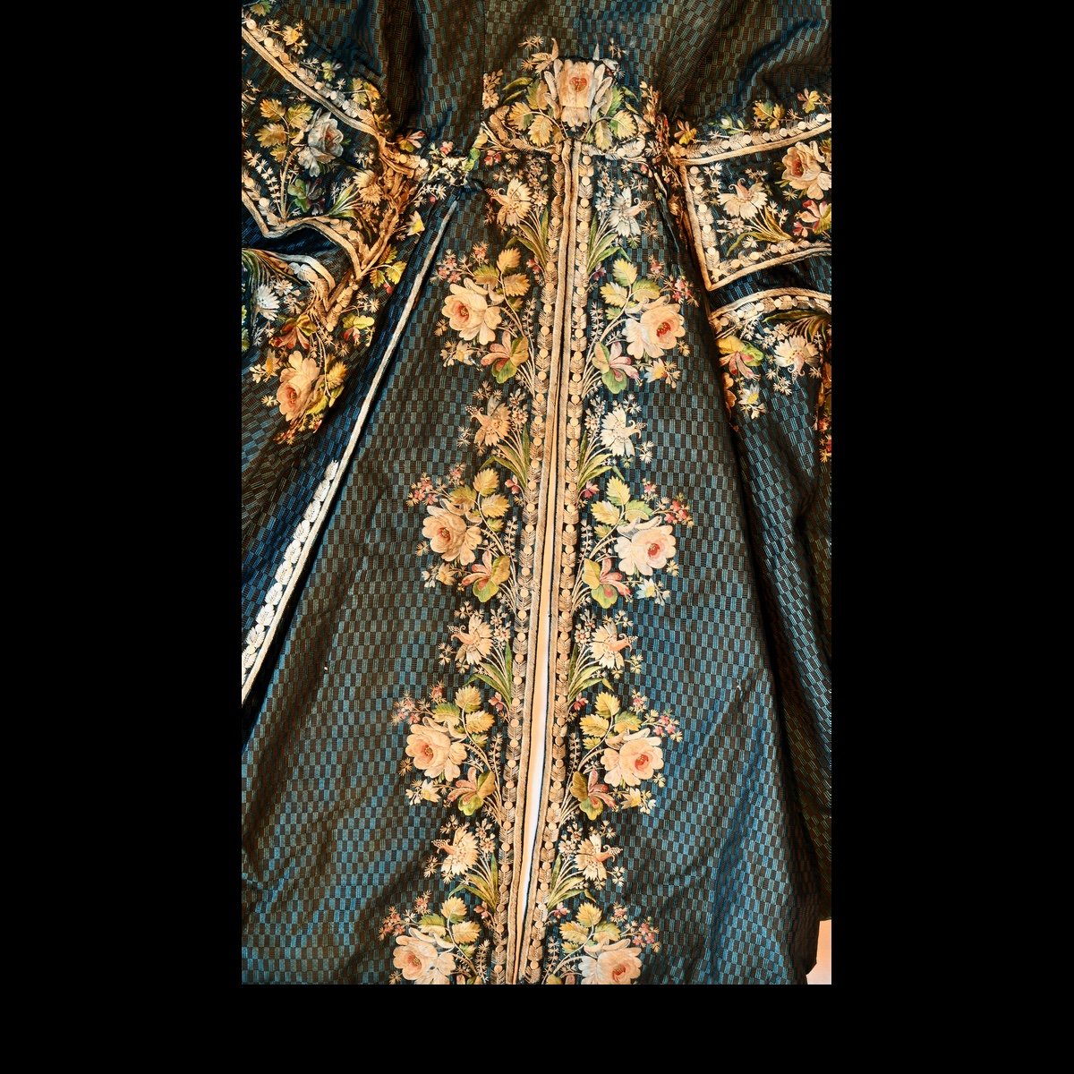 Detail of green patterned silk coat