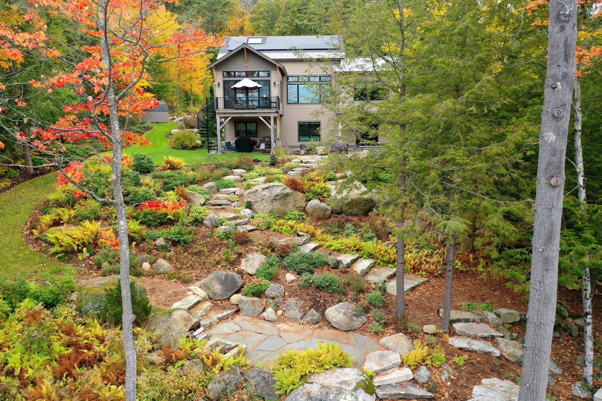 This stone stairway winds gracefully through the property, offering both function and artistry. Each step is a seamless continuation of the landscape, inviting exploration and elevating the natural beauty of the space. 

#gardeninspiration #dronephot