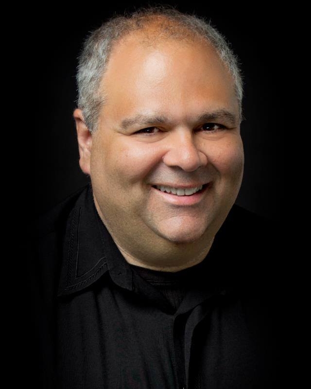 Mike Buzzelli Development Director  Mike is a stand-up comedian and published author. His book, "Below Average Genius" is a collection of essays culled from his weekly humor column in the Observer-Reporter.