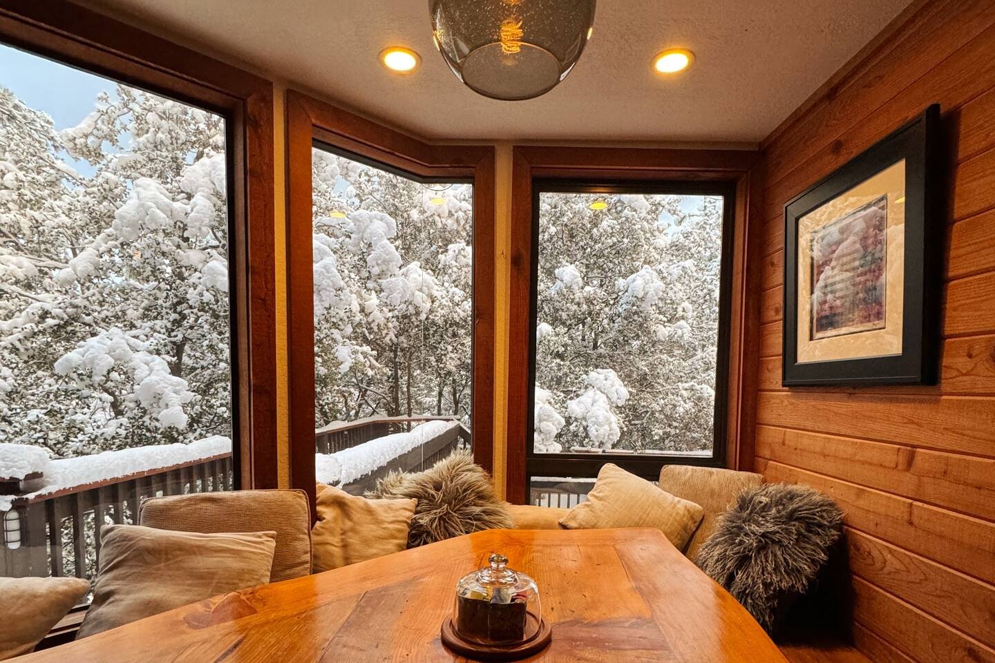 Snow-covered outdoor dining table on the winter deck at Faerie House Idyllwild