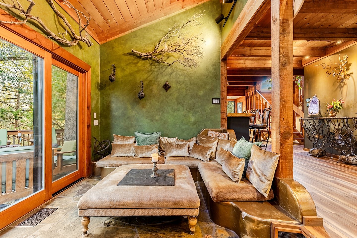 Stone fireplace with warm firelight in the winter great room of Faerie House Idyllwild mountain cabin